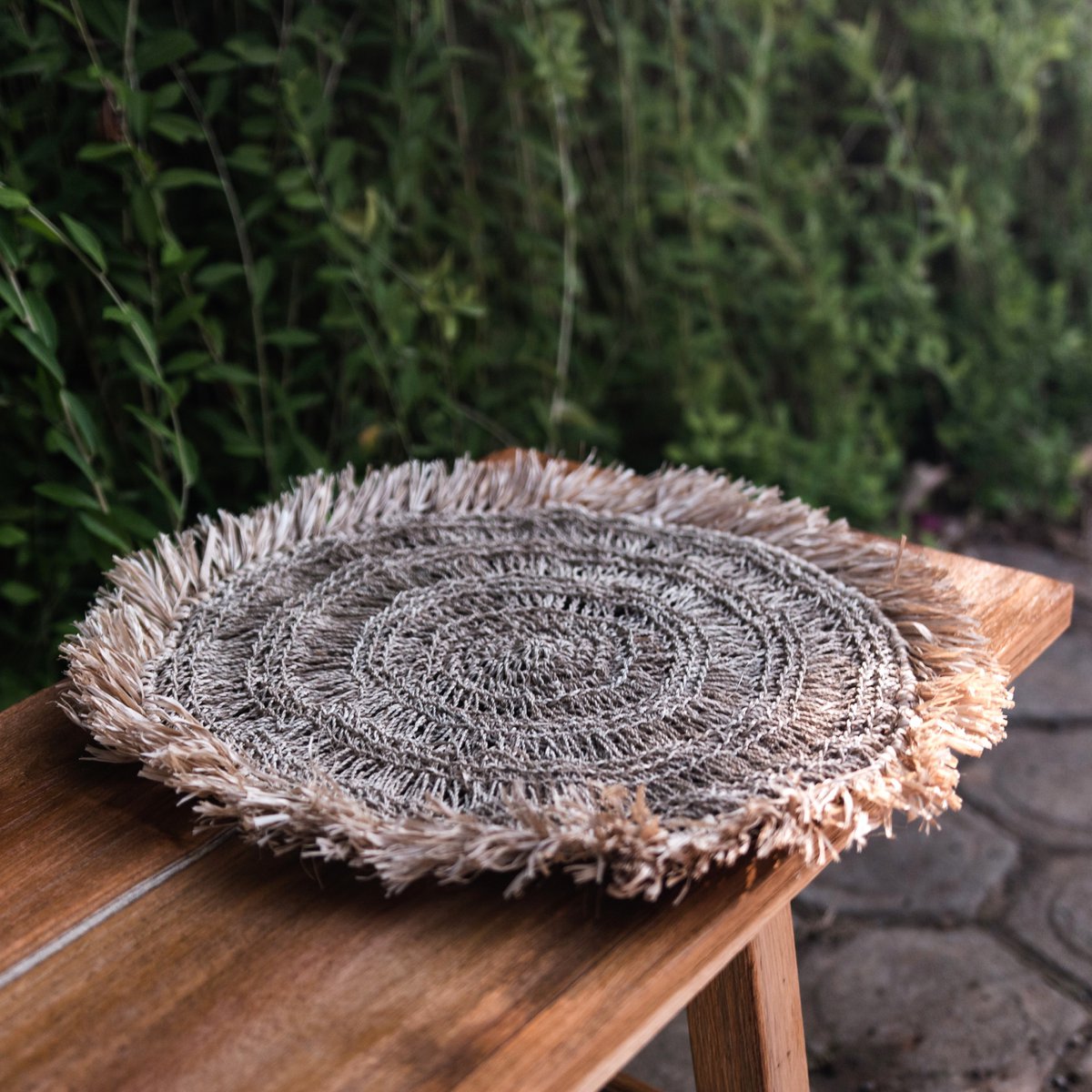 Placemat van raffia op een houten bankje